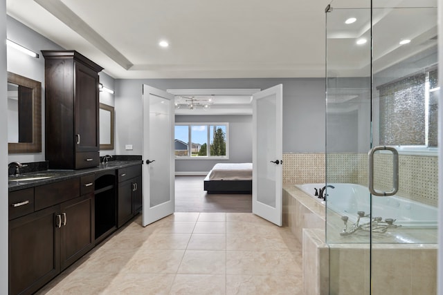 bathroom with vanity, independent shower and bath, and tile patterned flooring