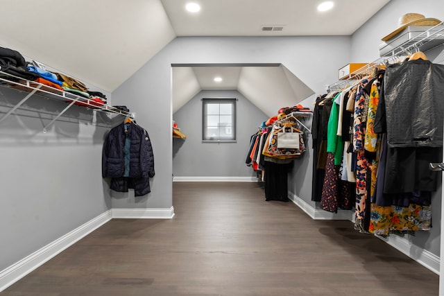 walk in closet featuring dark wood-type flooring and vaulted ceiling