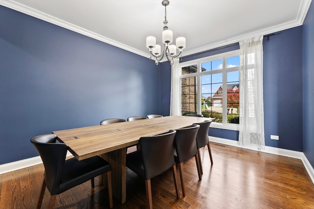 dining space with an inviting chandelier, ornamental molding, and dark hardwood / wood-style flooring