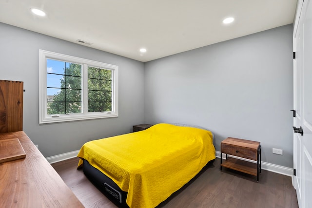 bedroom with dark hardwood / wood-style floors