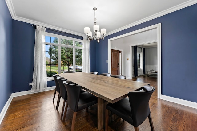 dining area featuring a notable chandelier, ornamental molding, and dark wood-type flooring