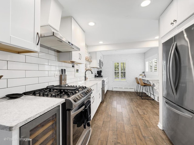 kitchen with white cabinets, wine cooler, wall chimney exhaust hood, dark hardwood / wood-style flooring, and stainless steel appliances