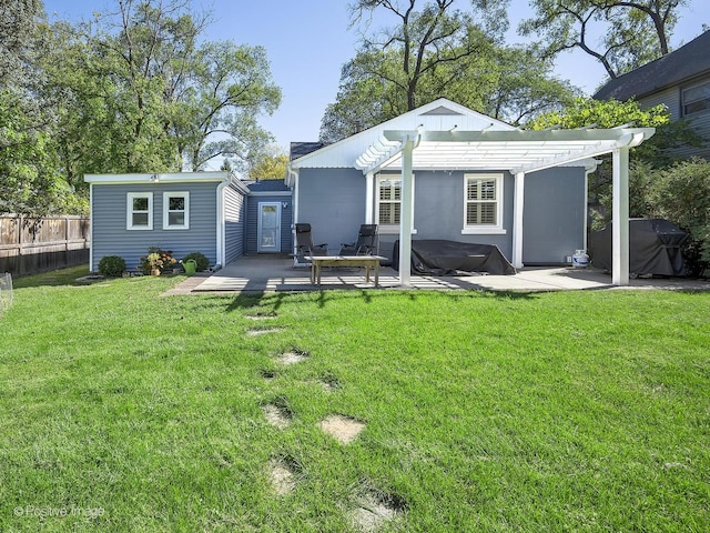 back of house with a yard, a pergola, and a patio