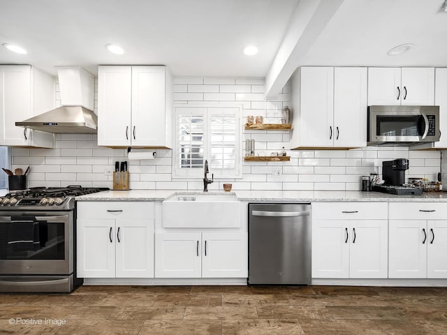 kitchen featuring light stone countertops, sink, white cabinets, and stainless steel appliances