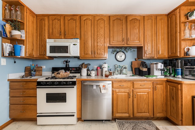 kitchen featuring white appliances and sink