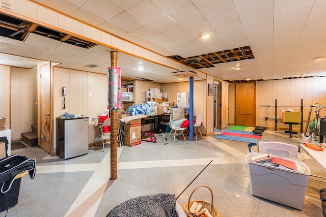 basement featuring wooden walls