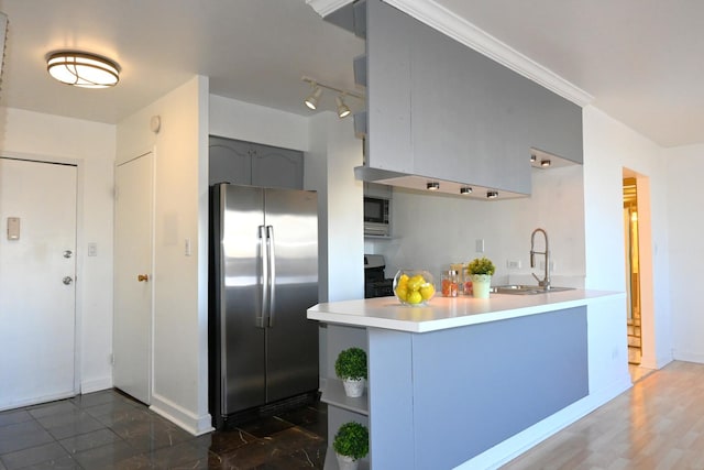 kitchen featuring sink, appliances with stainless steel finishes, and kitchen peninsula