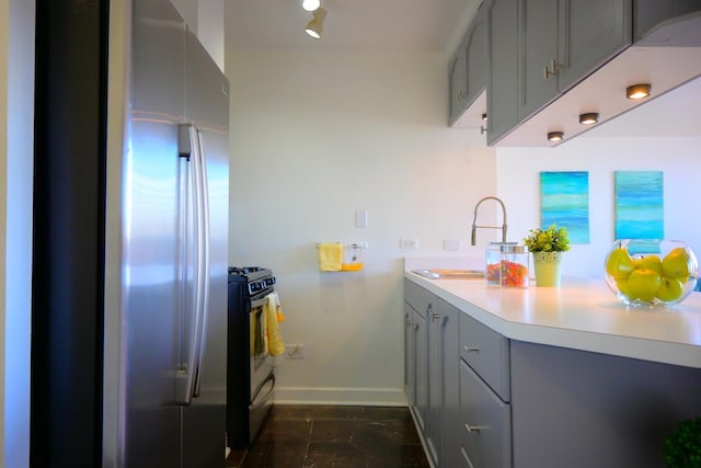 kitchen with sink, stainless steel appliances, and gray cabinets