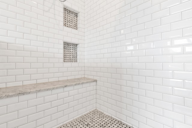 bathroom with a tile shower