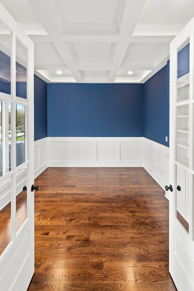 unfurnished room featuring coffered ceiling, dark hardwood / wood-style flooring, beamed ceiling, and french doors