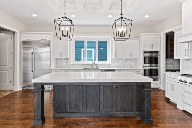 kitchen with appliances with stainless steel finishes, tasteful backsplash, and white cabinetry