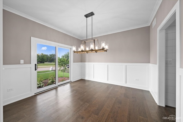 unfurnished dining area featuring crown molding, an inviting chandelier, and dark wood-type flooring