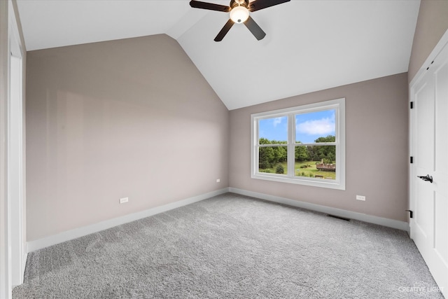 unfurnished bedroom featuring ceiling fan, carpet flooring, and vaulted ceiling