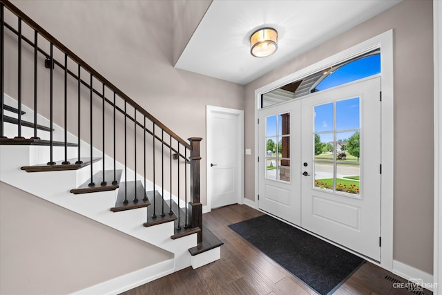 entrance foyer with dark hardwood / wood-style flooring and french doors