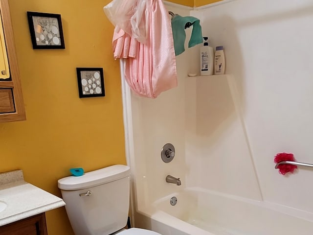 full bathroom with washtub / shower combination, vanity, and toilet