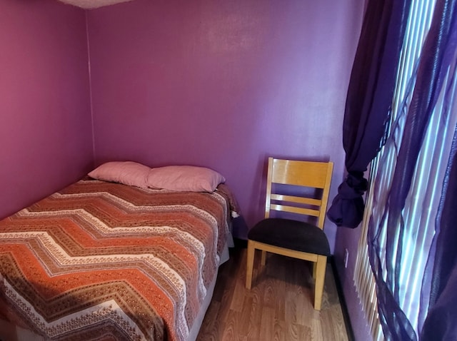 bedroom with wood-type flooring