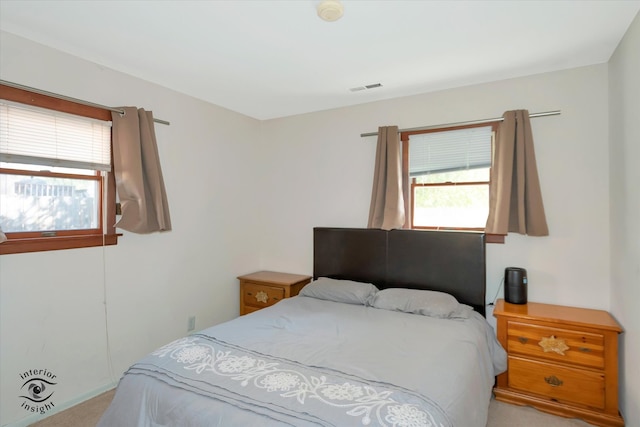 bedroom featuring light colored carpet