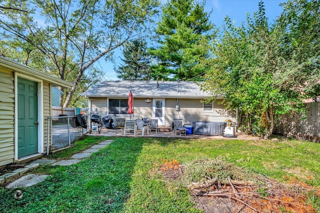 rear view of property featuring a patio and a yard