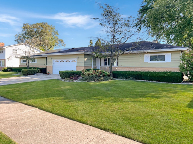 ranch-style home with a garage and a front yard