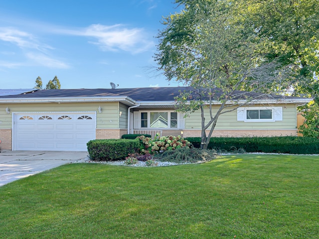 ranch-style home with a garage and a front lawn