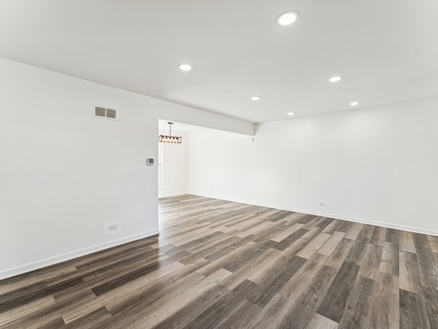 empty room with dark hardwood / wood-style flooring