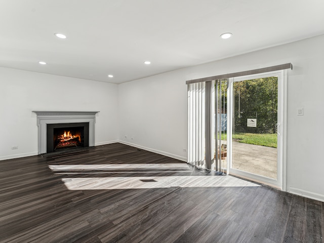 unfurnished living room with dark hardwood / wood-style floors