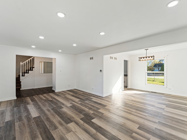 unfurnished living room featuring wood-type flooring