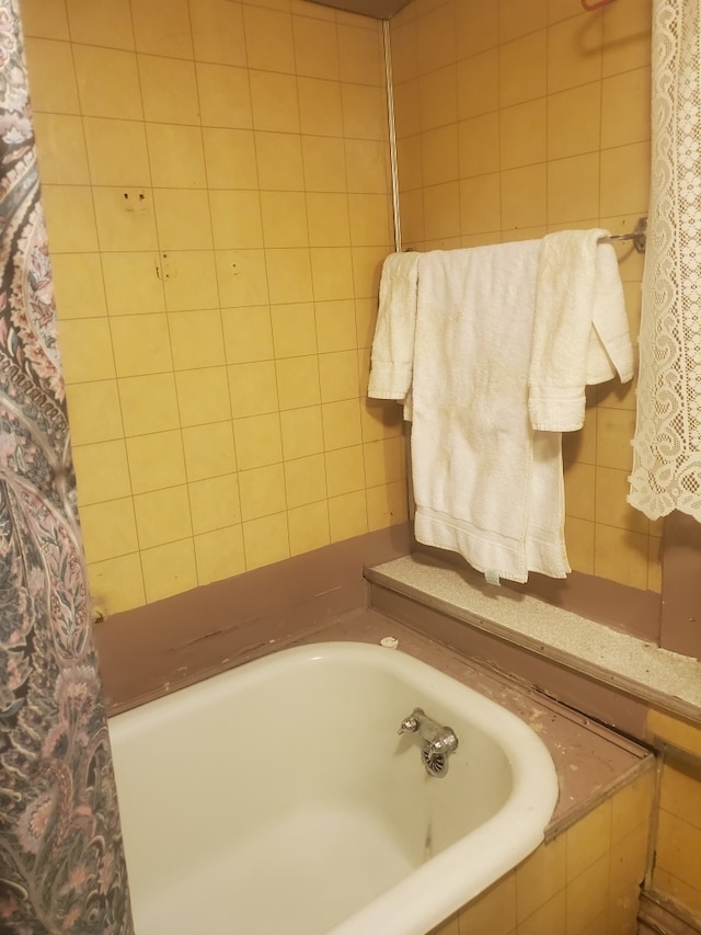 bathroom with a relaxing tiled tub