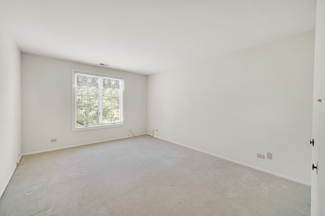 unfurnished room with light colored carpet