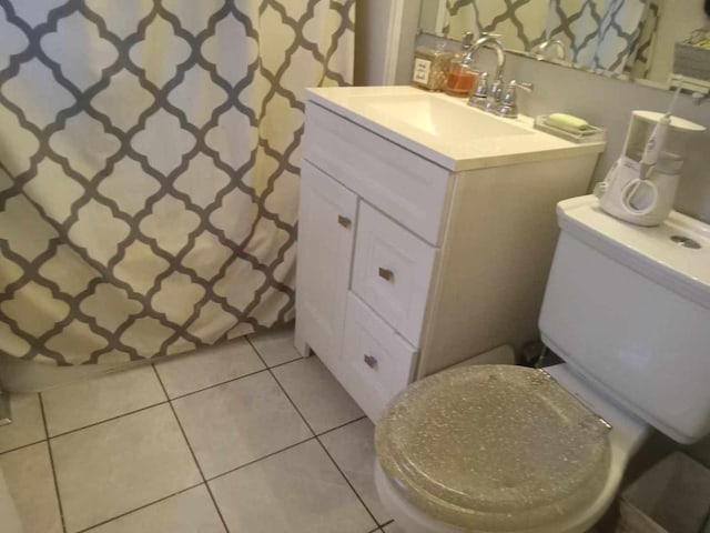 bathroom featuring tile patterned floors, curtained shower, vanity, and toilet