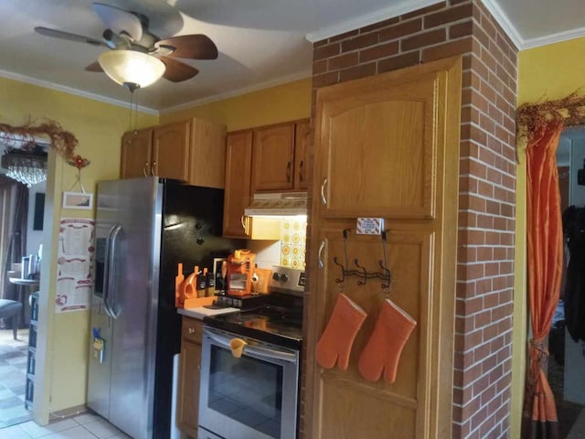 kitchen with ornamental molding, ceiling fan, appliances with stainless steel finishes, and light tile patterned flooring