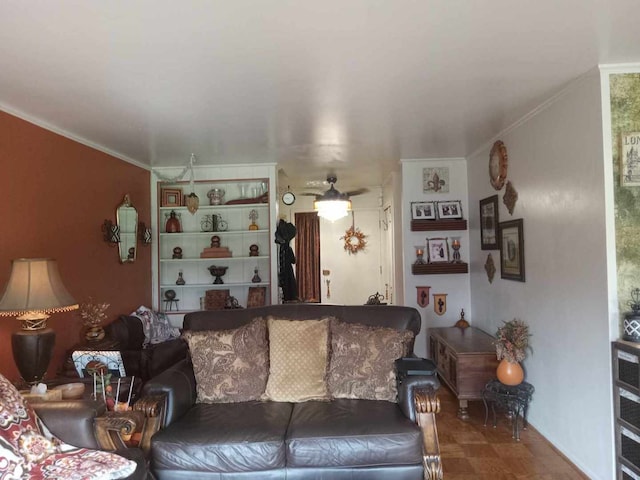 living room featuring crown molding and ceiling fan