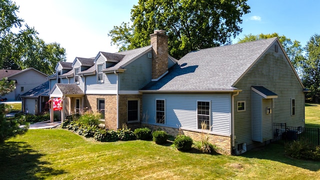 rear view of property with a lawn