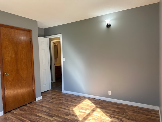 unfurnished bedroom featuring dark hardwood / wood-style flooring