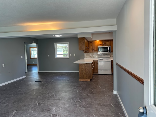 kitchen featuring a textured ceiling, backsplash, and electric stove