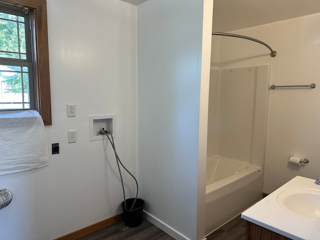 bathroom featuring vanity, tub / shower combination, and wood-type flooring