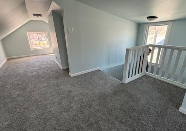 bonus room featuring dark carpet and lofted ceiling