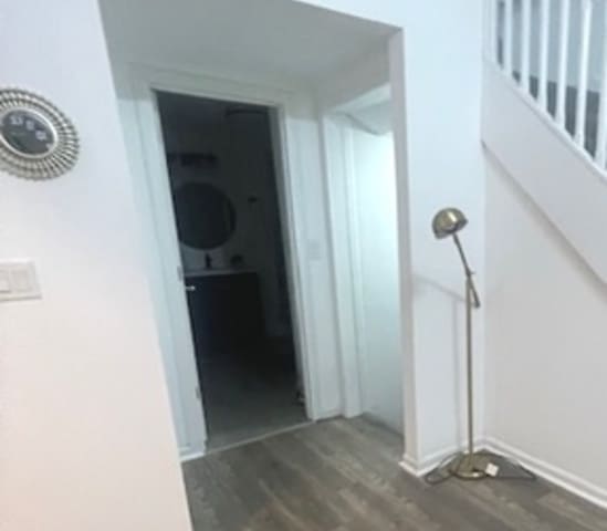 hallway with dark hardwood / wood-style flooring