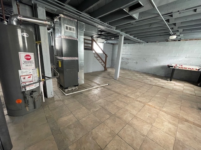 basement featuring water heater and heating unit