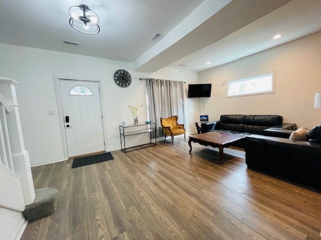 foyer entrance with an inviting chandelier and hardwood / wood-style flooring