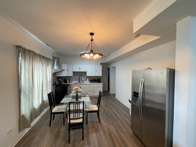 dining area with dark hardwood / wood-style flooring and sink