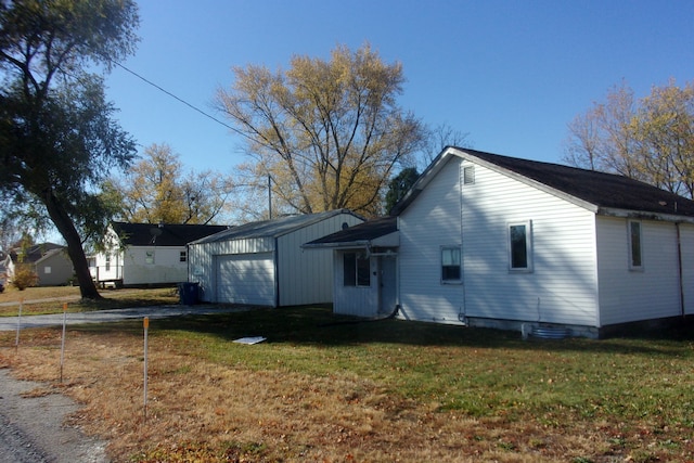 view of property exterior with an outbuilding, a yard, and a garage