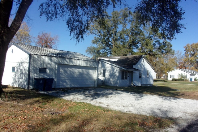 exterior space with an outbuilding and a garage