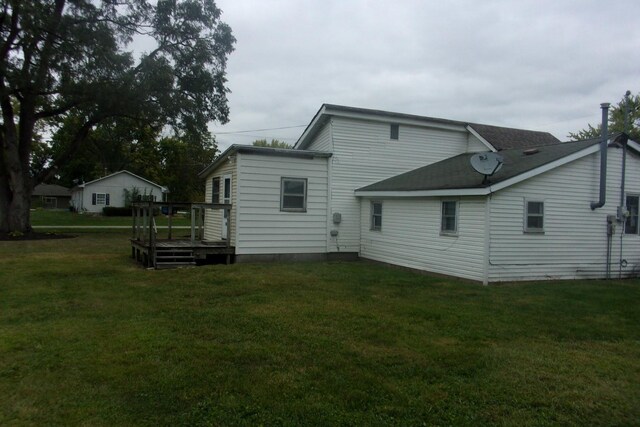 back of house with a lawn