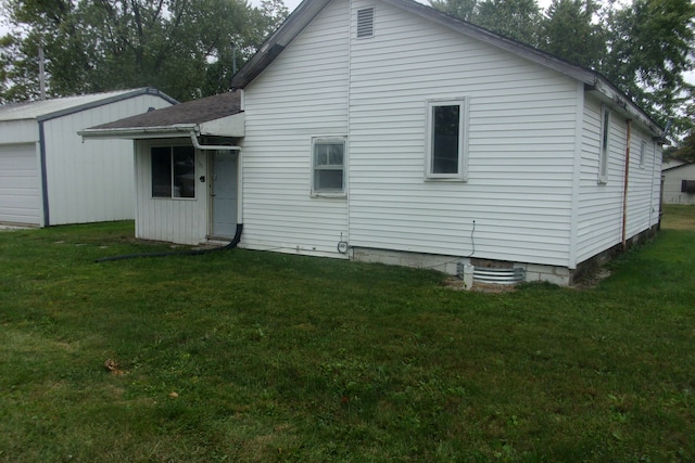 rear view of property featuring a yard