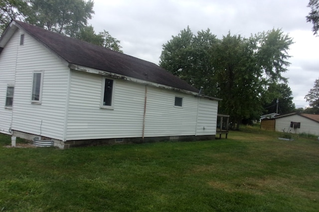 view of side of home with a lawn