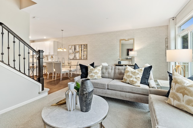 living room with a notable chandelier and wood-type flooring