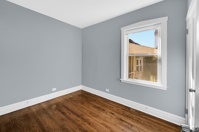 empty room with hardwood / wood-style flooring