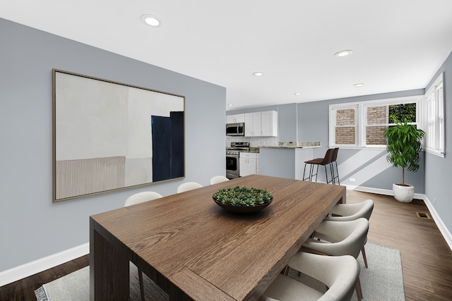 dining space featuring dark wood-type flooring