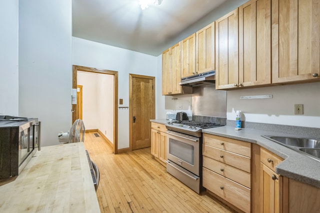 kitchen featuring sink, light brown cabinetry, appliances with stainless steel finishes, and light hardwood / wood-style flooring